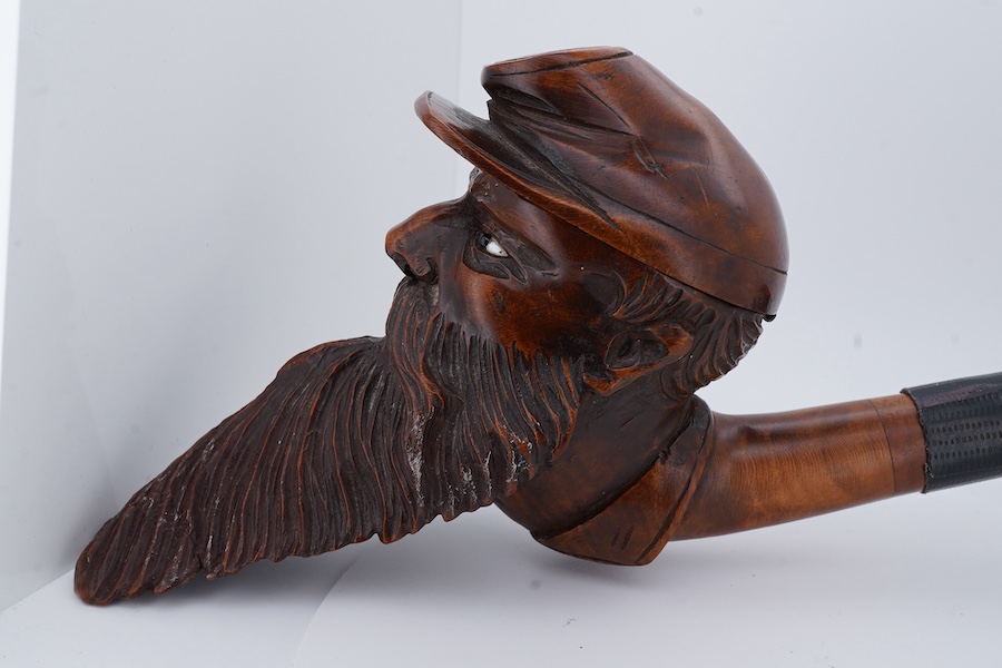An American Civil War briar pipe in the form of the head of a bearded soldier, with horn mouthpiece, 23cm long